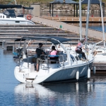 A large boat "Tropical Quest" pulling in for a docking on a sunny day