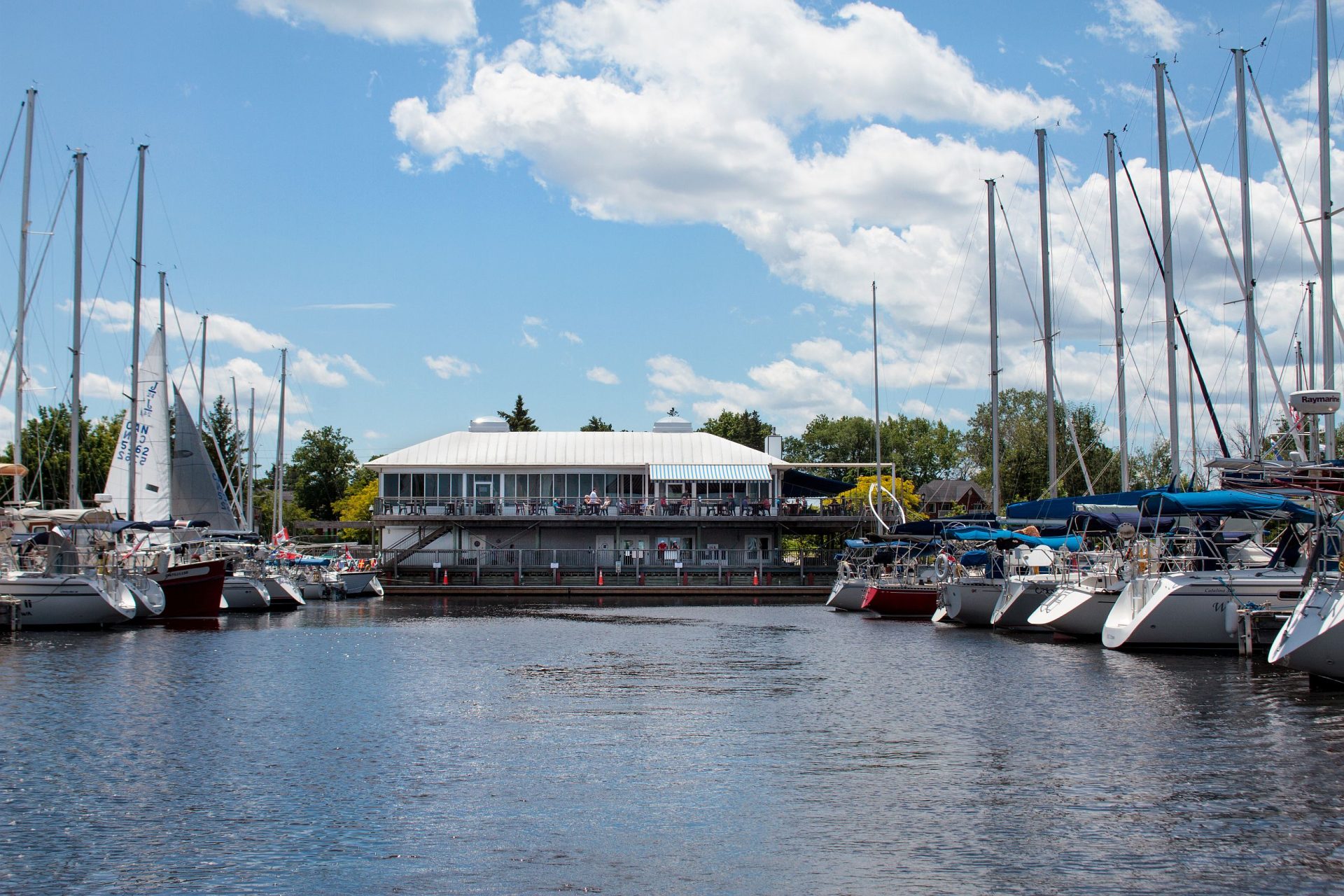 Clubhouse with some boats in docks on either side