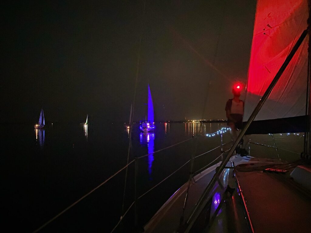 Illuminated sailboats racing at night