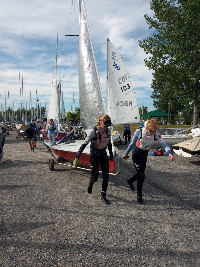 505 dinghy youth sailors pull their boat on its trailer