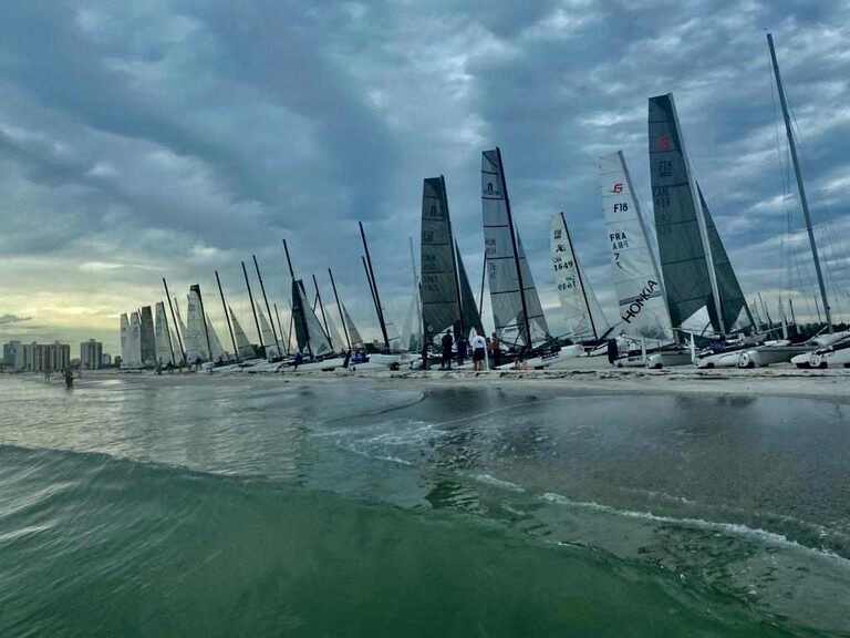 Formula 18s (F18s) catamarans line the beach at the 2022 World Championships in Clearwater, FL