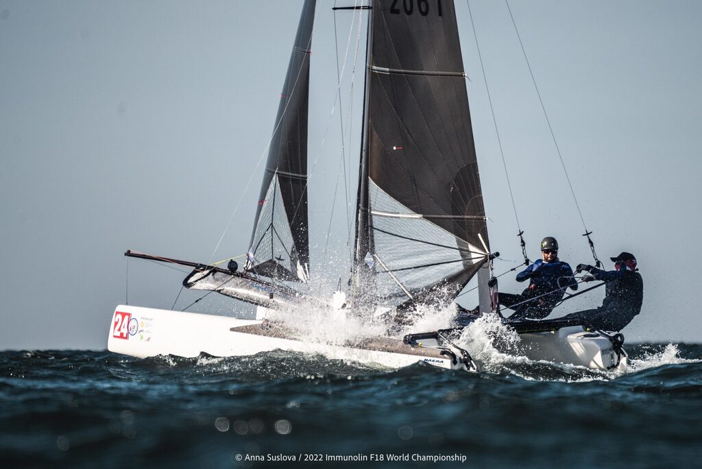 Two men sail a Formula 18 (F18) catamaran in rough water