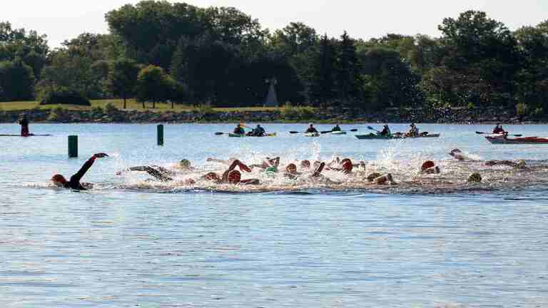 Kayakers watch over open water swimmers in Bring On The Bay