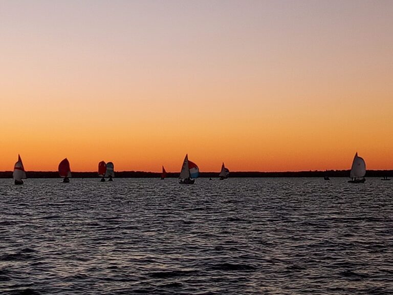 Sailboats racing at sunset