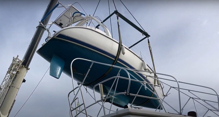 Boat lifted in the air by a crane