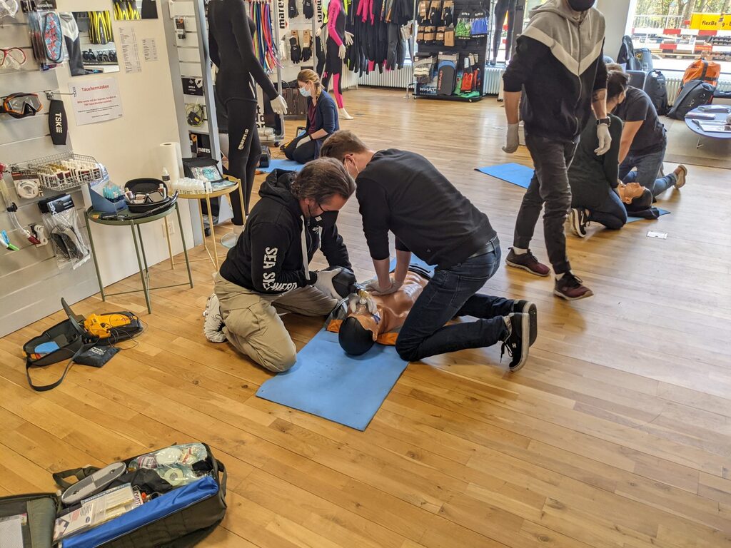 First aid class with people doing CPR on a dummy