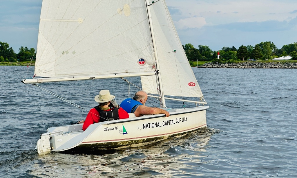 2 people sailing at the Nepean Club in a Martin 16 sailboat  which is designed for people for disabilities