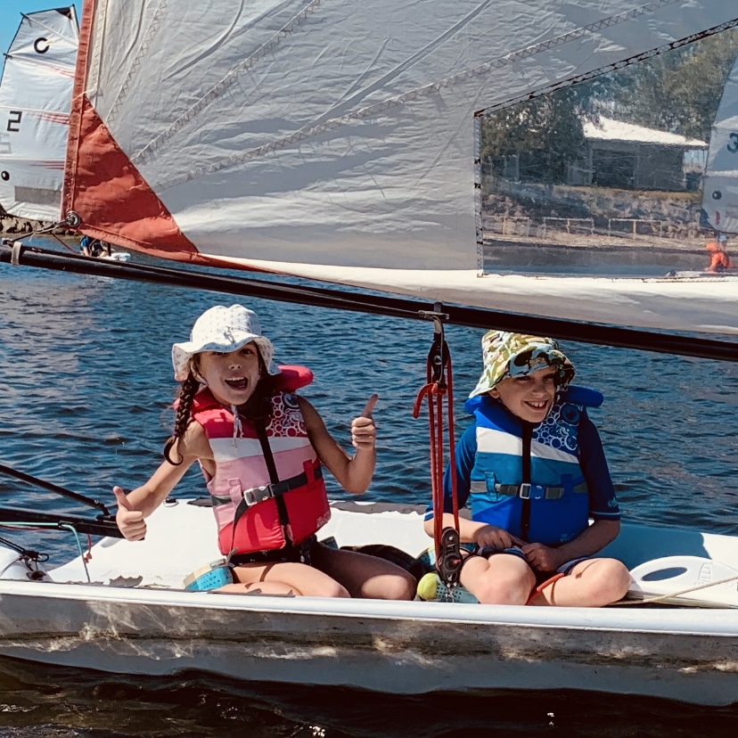 Boy and girl sailing a dinghy